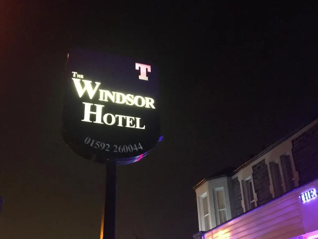 The illuminated Windsor Hotel sign on Victoria Road, Kirkcaldy at night